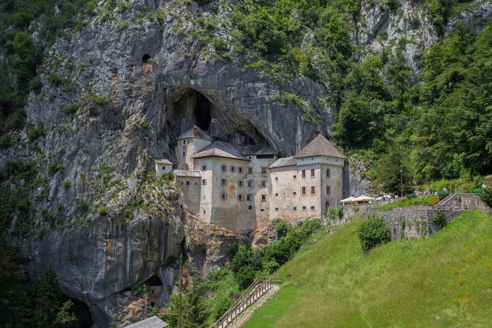 Predjama Castle built into the mouth of a cave halfway up a limestone cliff